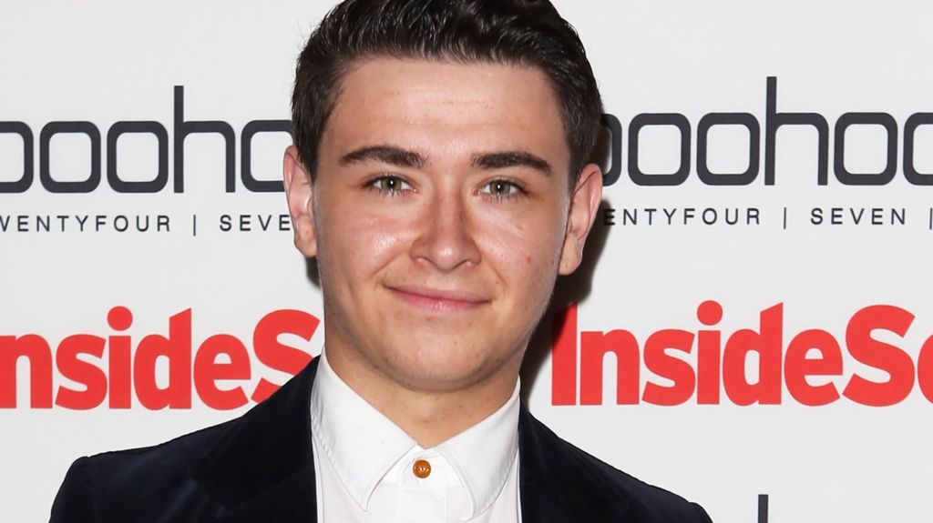 William Rush at an awards ceremony, smiling at the camera. He is wearing a suit. 