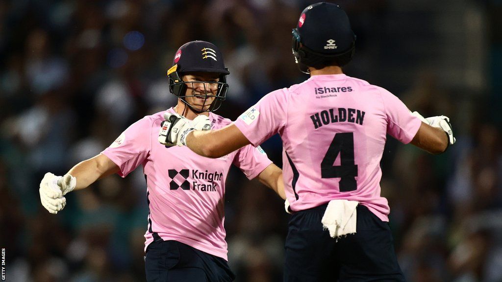 Middlesex players Max Holden and Jack Davies celebrate their win over Surrey