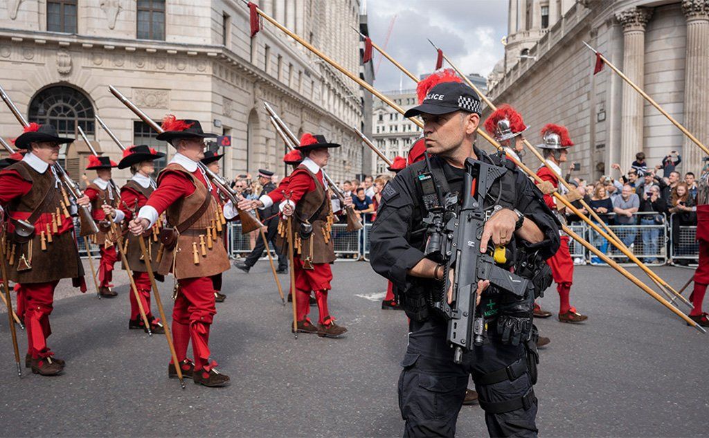 The Company of Pikemen and Musketeers march past armed police and the Bank of England, London, 9 September 2022