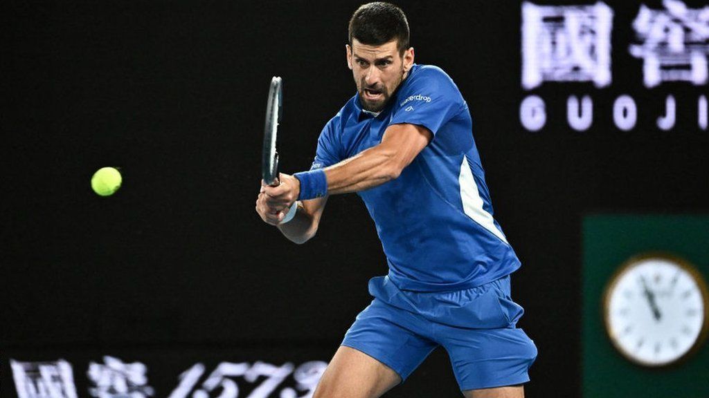 Serbia's Novak Djokovic hits a return against Australia's Alexei Popyrin