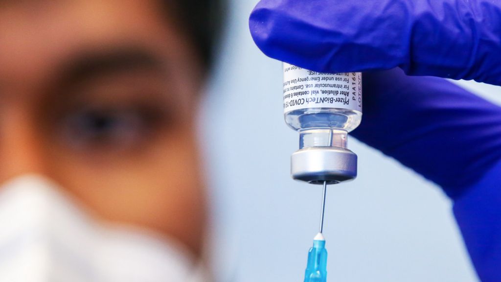 Nurse prepares a Pfizer vaccine