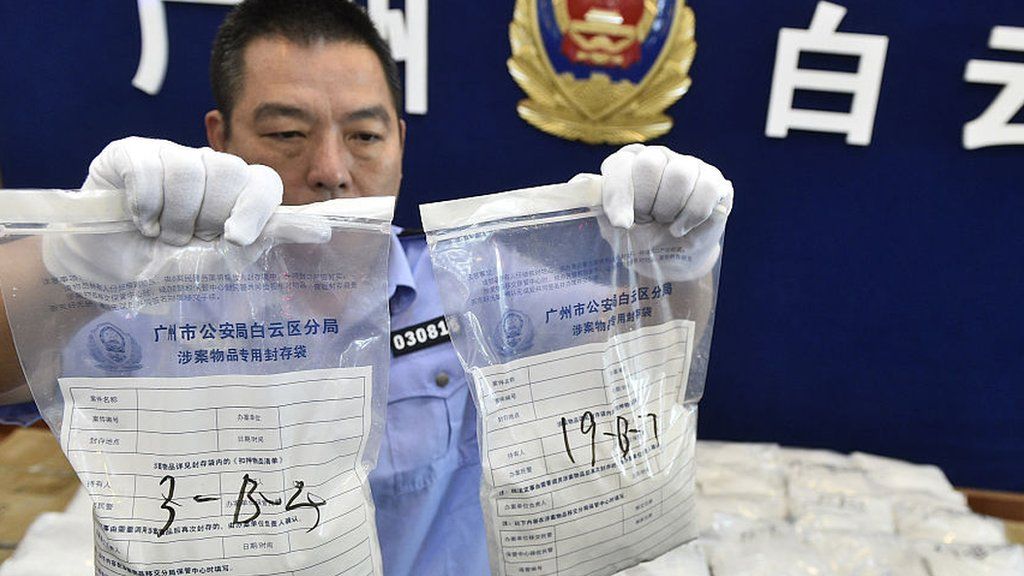 The police officer shows the seized crystal meth on May 18, 2016 in Guangzhou, Guangdong Province of China.