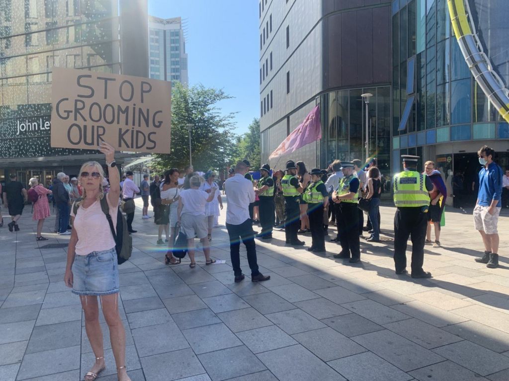 A protester holds a sign saying 'Stop grooming Our Kids' outside Cardiff Central Library