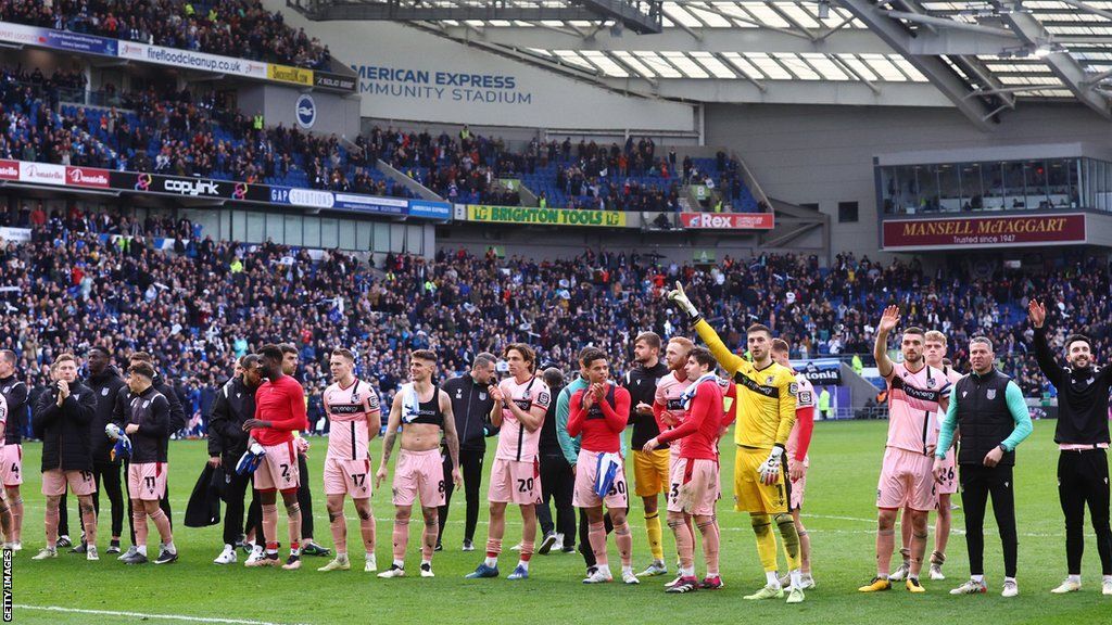 Grimsby Town players salute the fans after their FA Cup defeat at Brighton