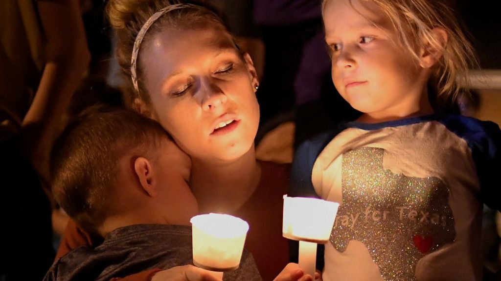 A woman and her children take part in a vigil for victims of a mass shooting in Sutherland Springs, Texas, US., November 5, 2017.