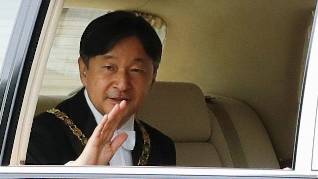 Emperor Naruhito waves from his car