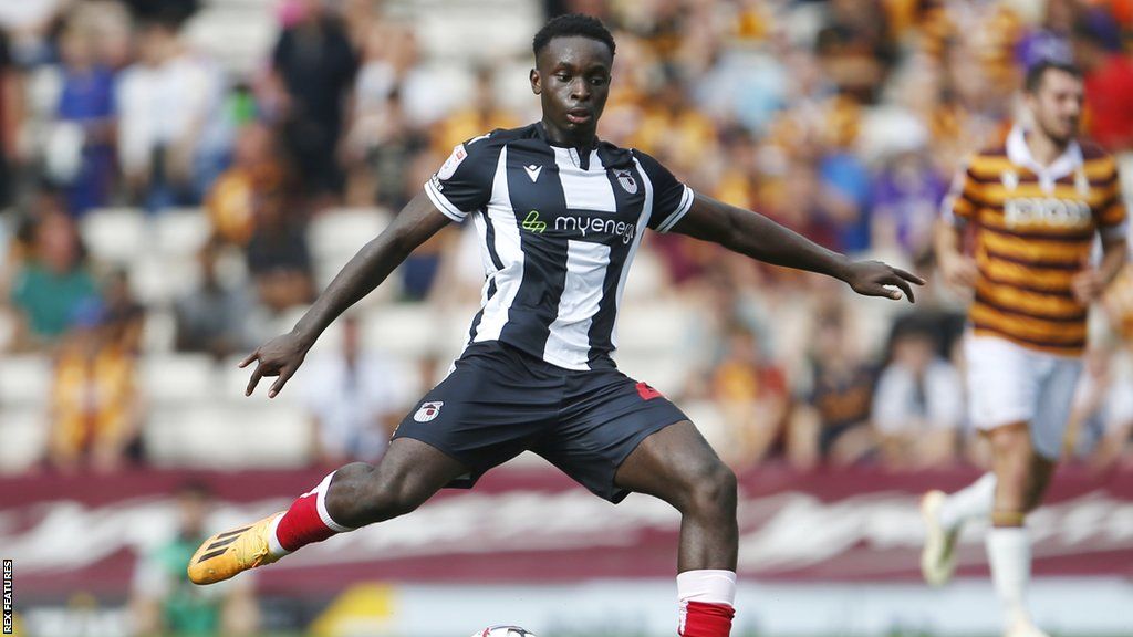 Kamil Conteh swings his leg to kick the ball during a game for Grimsby earlier this season
