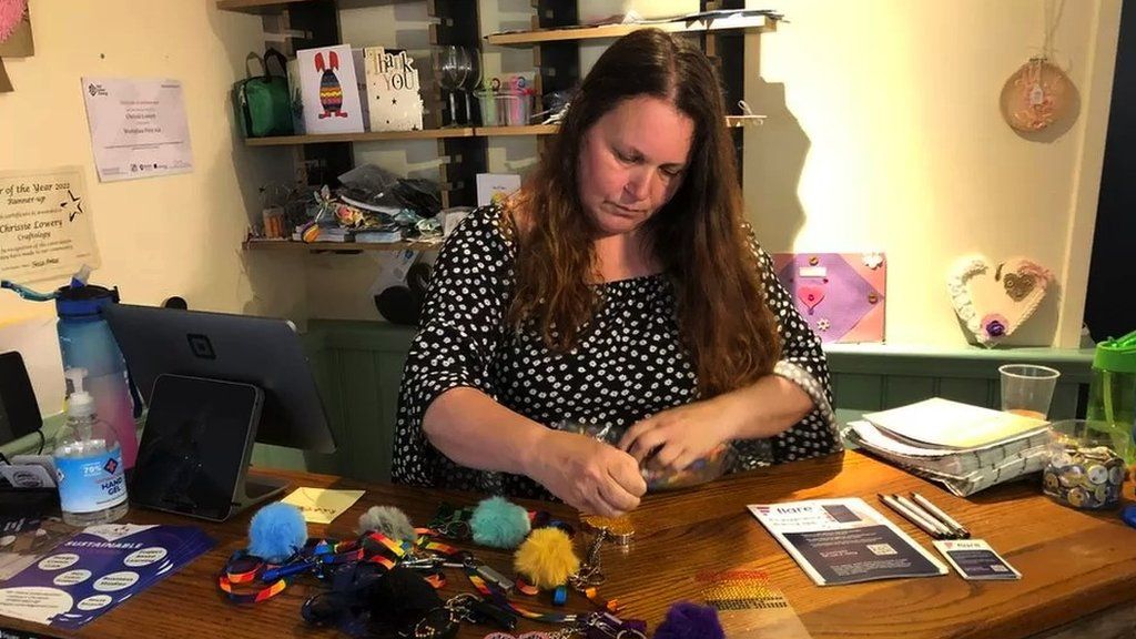 Chrissie Lowery working in her craft shop.