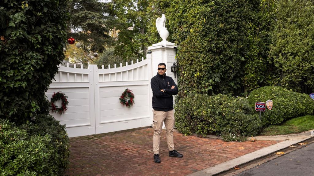 A guard stands in front of the Reiner home