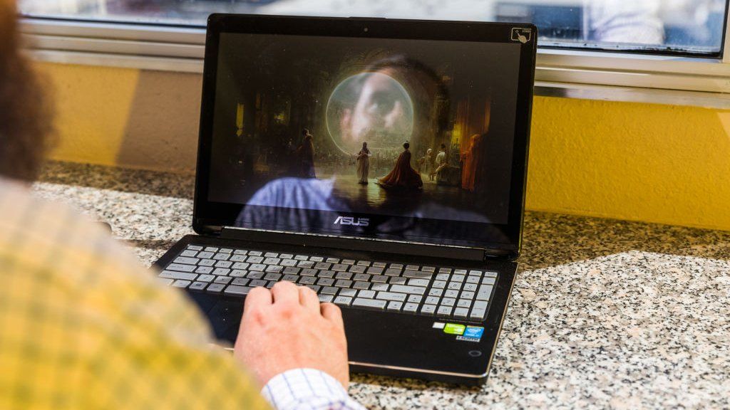 The winner of an art competition looks at AI generated art on his laptop