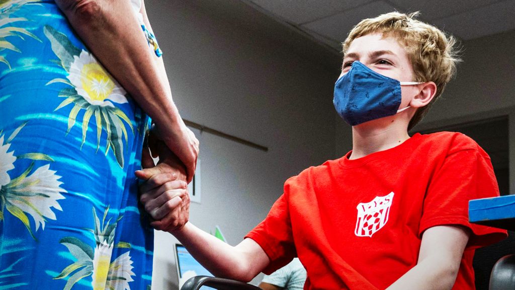 The boy is waiting for a vaccine in the US