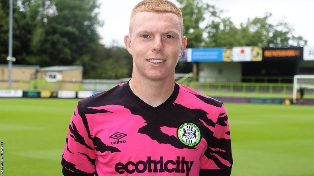 Alfie Bendle wears a pink and black Forest Green Rovers shirt at the Bolt New Lawn at his unveiling by the League Two club
