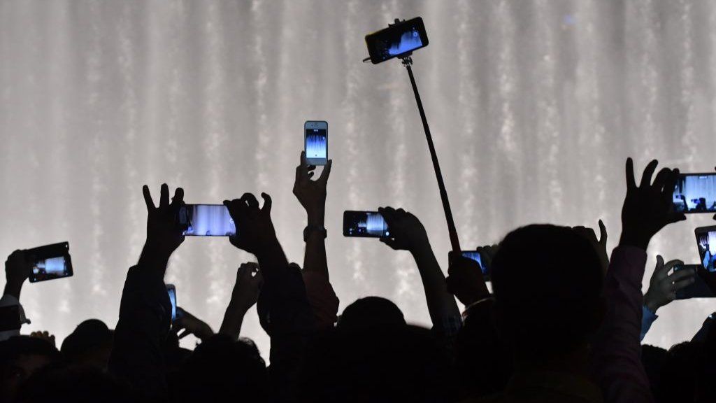 people holding up phones