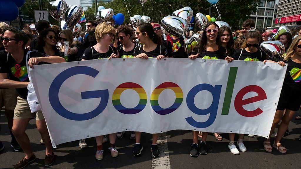 People march with a Google banner