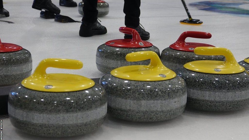 Curling stones resting on an ice rink
