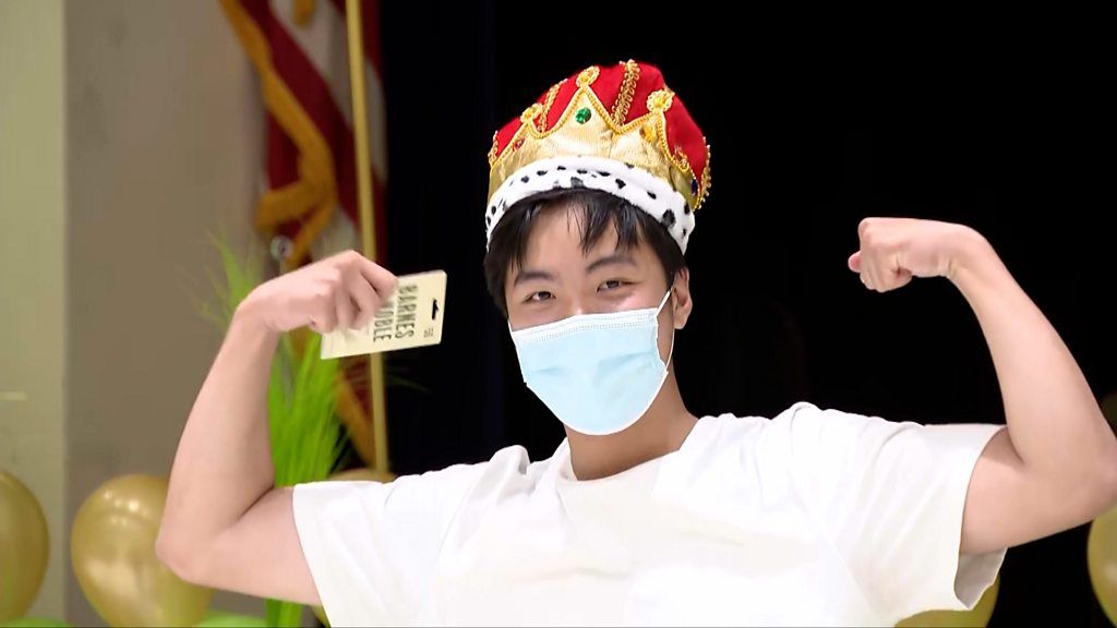 A student wears a crown to celebrate receiving the most college rejection letters.