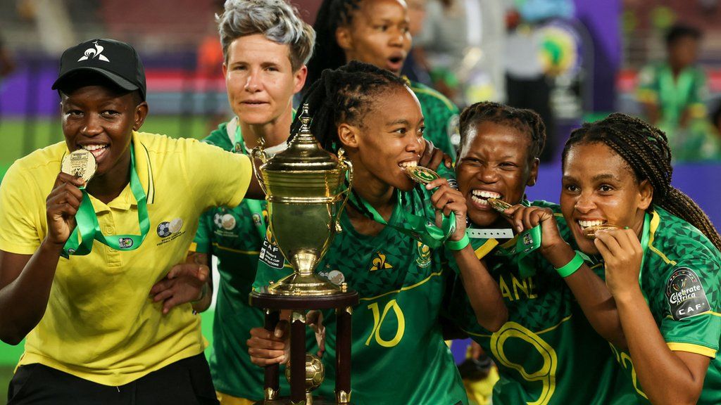 South Africa players celebrate with medals and the trophy after beating Morocco to win the 2022 Women's Africa Cup of Nations