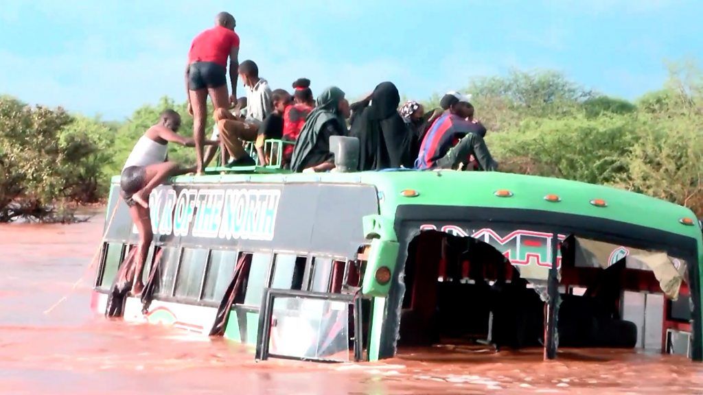 Passengers stuck on top of submerged bus