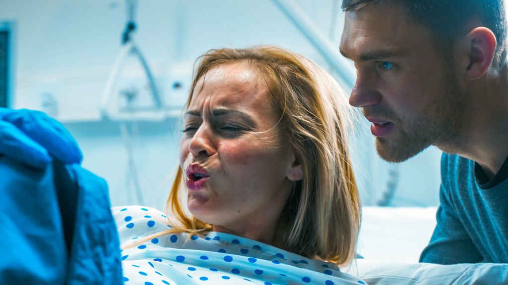 Stock image of woman giving birth in hospital