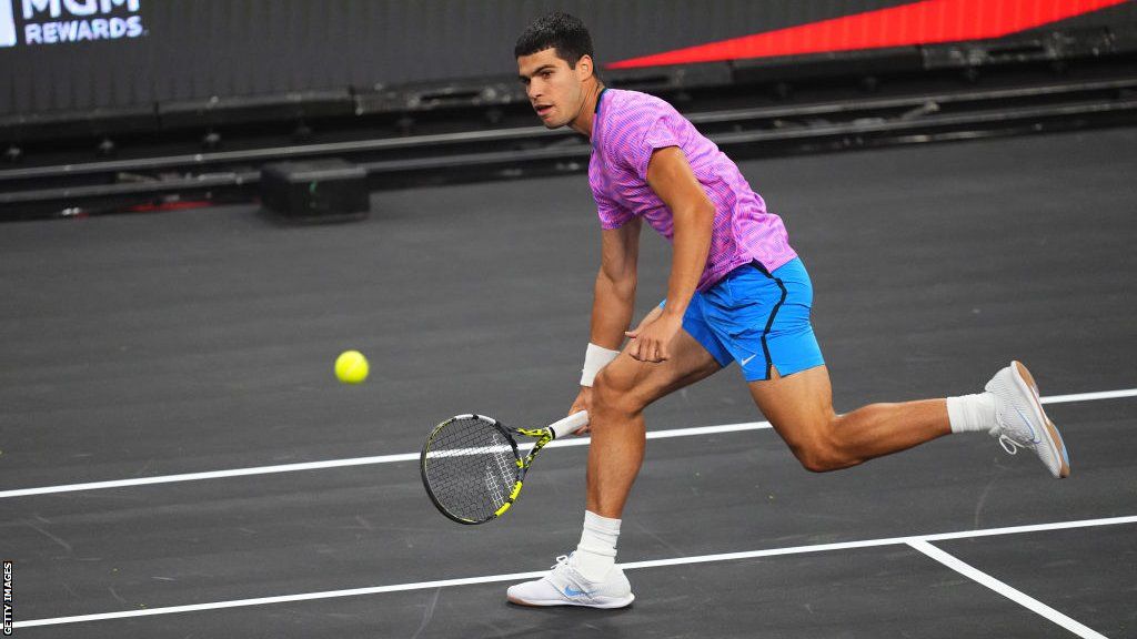 Carlos Alcaraz chases after a ball as he prepares to hit a forehand