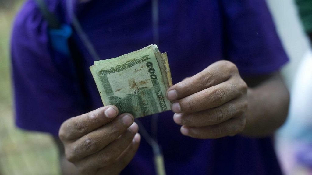 Man holding Bangladeshi money