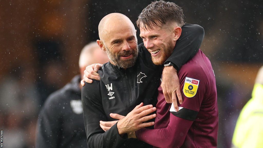 Derby County manager Paul Warne (left) and midfielder Max Bird (right) embrace