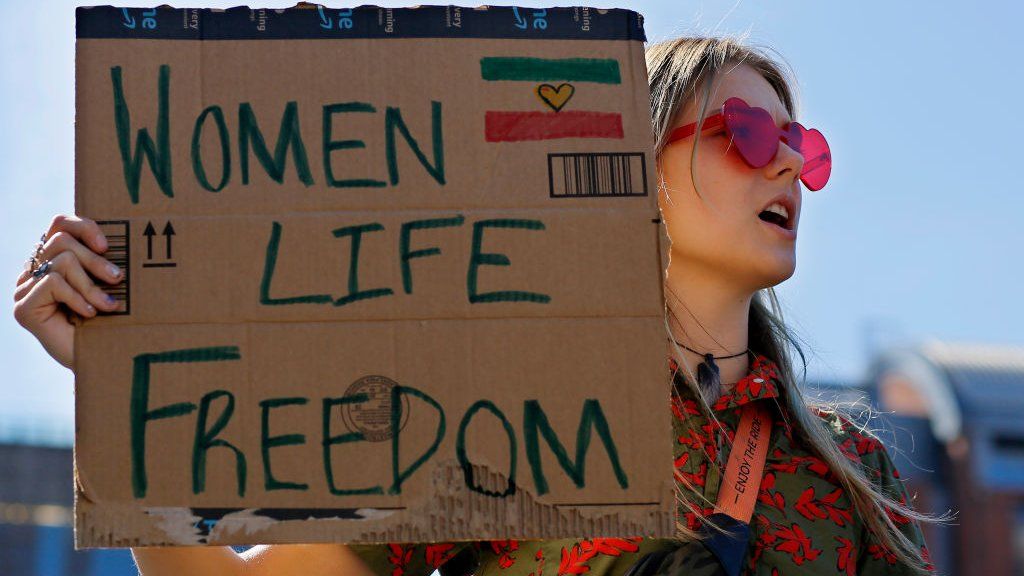 A woman protests in support of Iranian women in New York in October