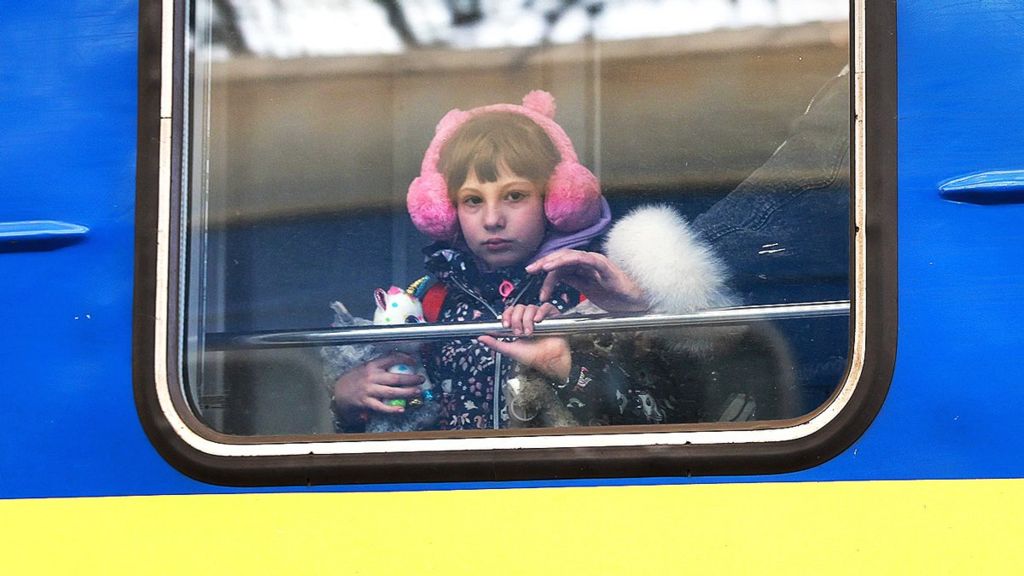 A child looks out the window of a train as it arrives in Lviv from Zaporizhzhia on 5 April 2022