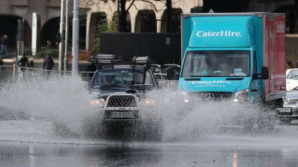 Cars navigate a flooded street in Dublin as the tail end of Storm Diana crosses the East Coast of Ireland
