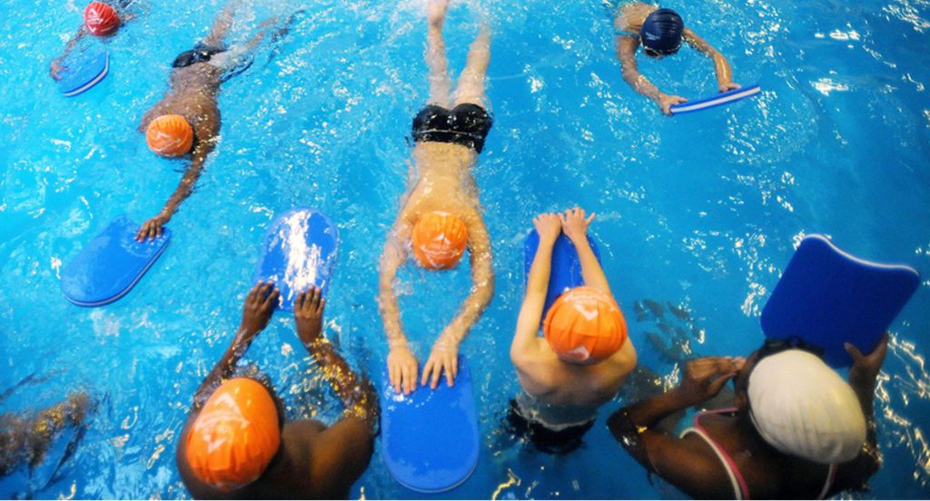 Children swimming with floats