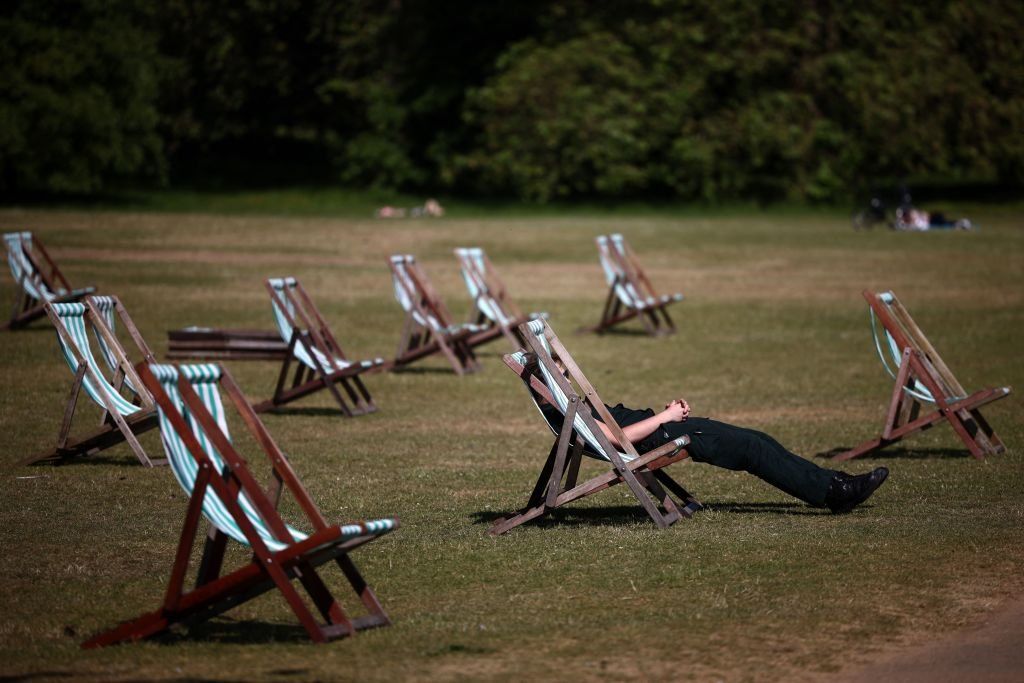 People sit on deckchairs in the sunshine in Hyde Park in central London, 8 June 2023.