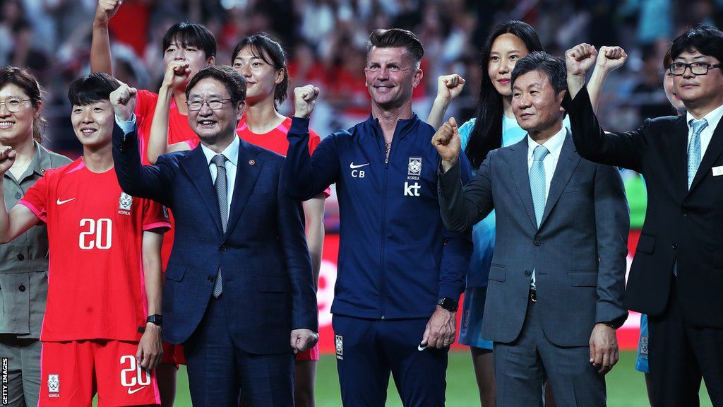 Colin Bell with South Korea players and officials