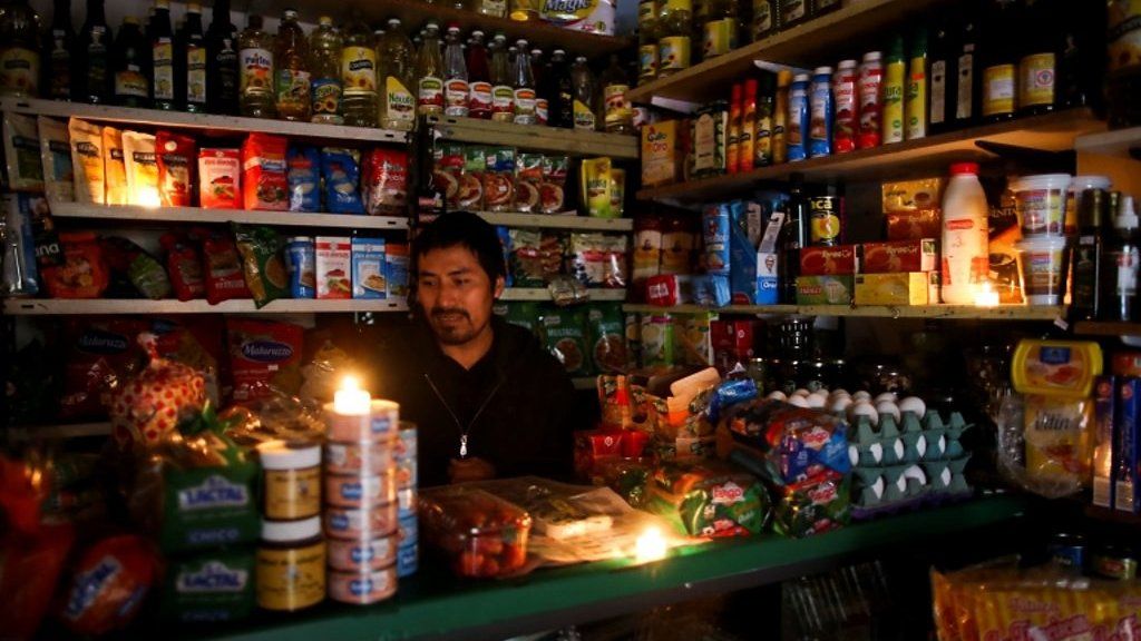 A vendor waits for customers during a national blackout, in Buenos Aires