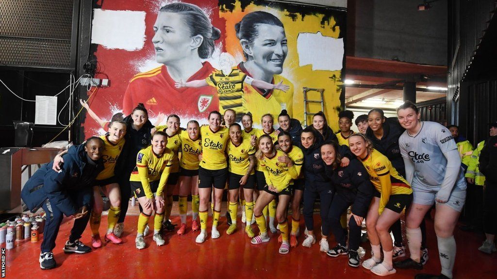 Helen Ward and her Watford team-mates pictured alongside the new mural