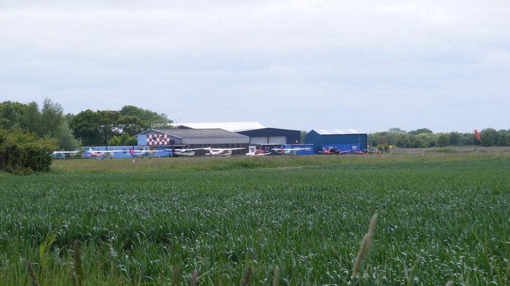 A picture of the airfield at Beccles, Suffolk, showing light aircraft and hangars