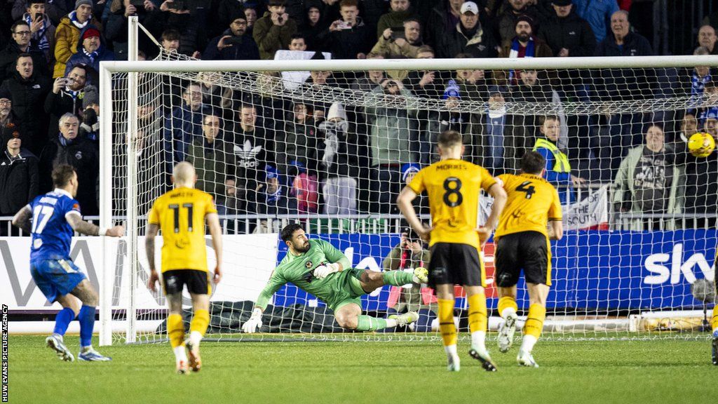 Chris Maguire's late penalty at Rodney Parade earned 10-man Eastleigh a replay