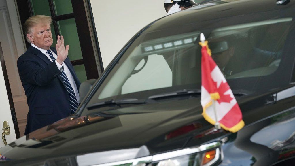 Trump waves to car carrying the Canadian PM