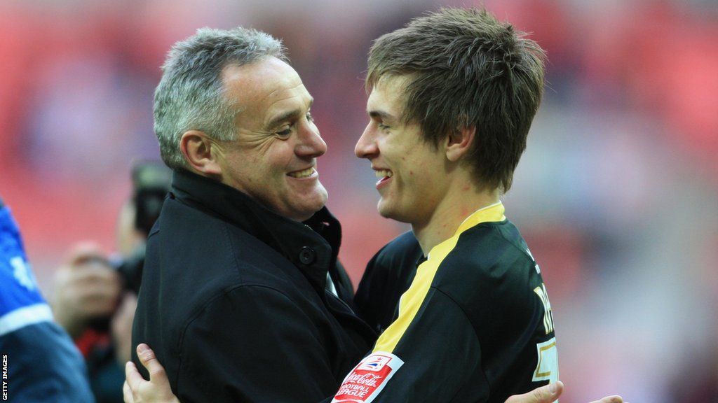 Aaron Ramsey is embraced by Cardiff manager Dave Jones