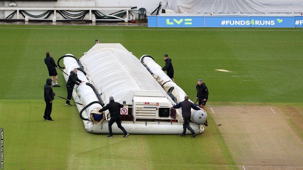 Groundstaff had to wrestle with a malfunctioning cover on a rain-affected first day