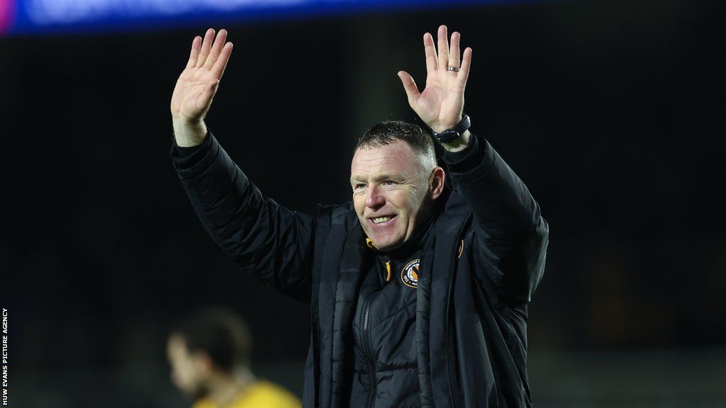 Newport County boss Graham Coughlan celebrates with fans