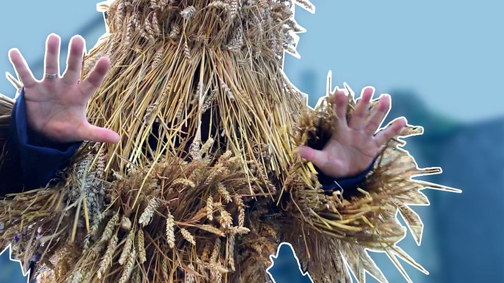Man in straw bear outfit