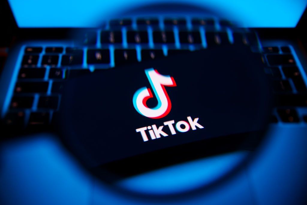 The TikTok logo under a magnifying glass