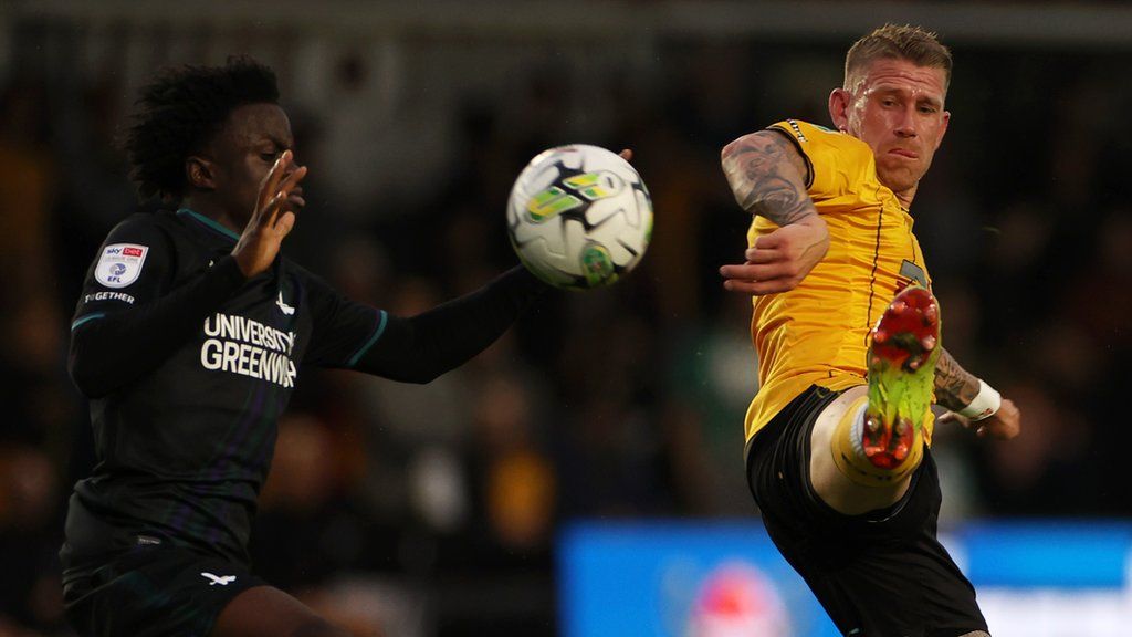 Scot Bennett of Newport County (R) is challenged by Tyreece Campbell of Charlton Athletic
