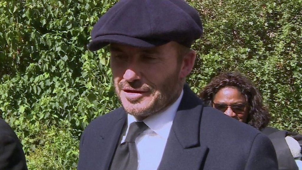 David Beckham standing in the queue