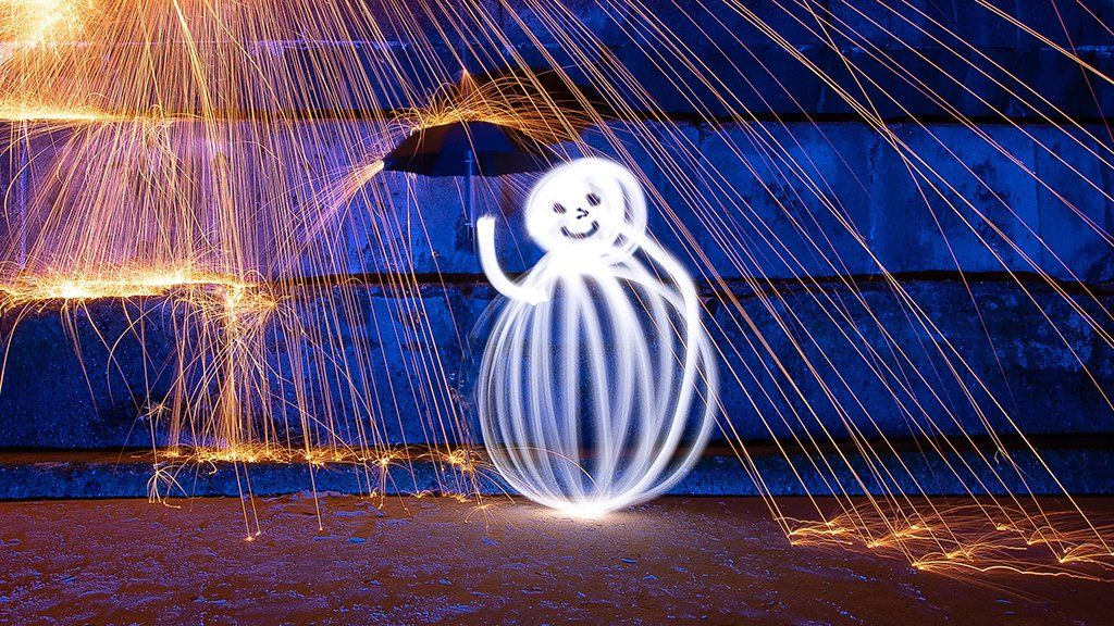 Snowman light painting with wire wool sparks on Frinton beach in Essex
