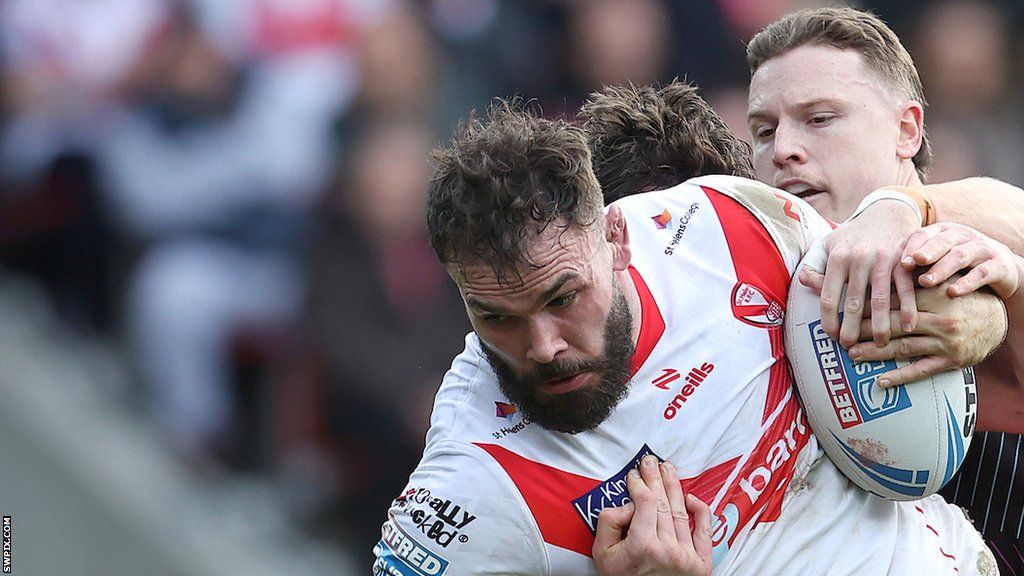 St Helens forward Alex Walmsley takes on the Wigan defence