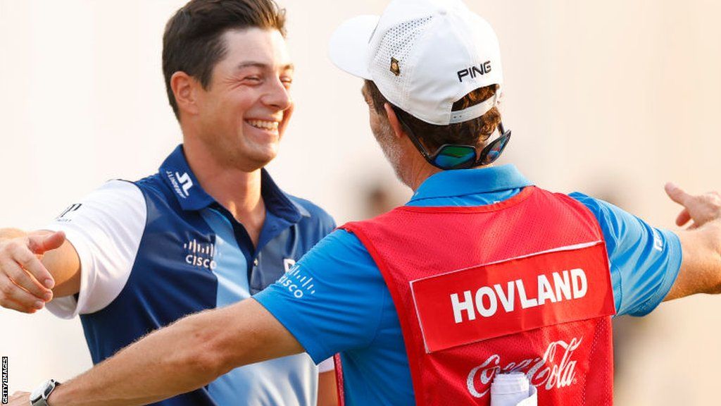 Viktor Hovland and his caddie embrace after his victory in the Tour Championship