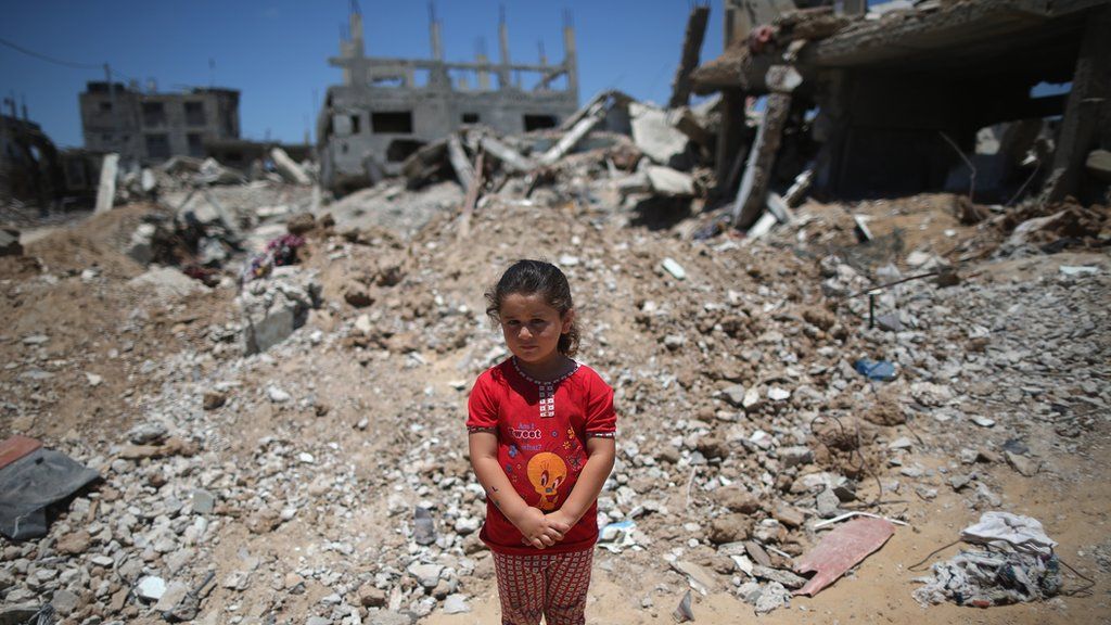 A child stands amid Gaza rubble, June 2015
