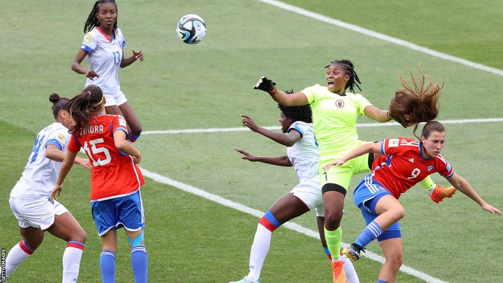 Kerly Theus punches the ball for Haiti against Chile