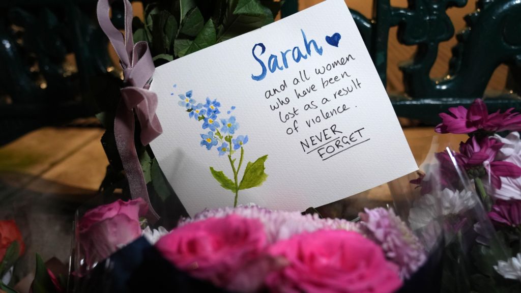Flowers laid and a card laid at a vigil marking five years since the death of Sarah Everard, at Clapham Common Bandstand